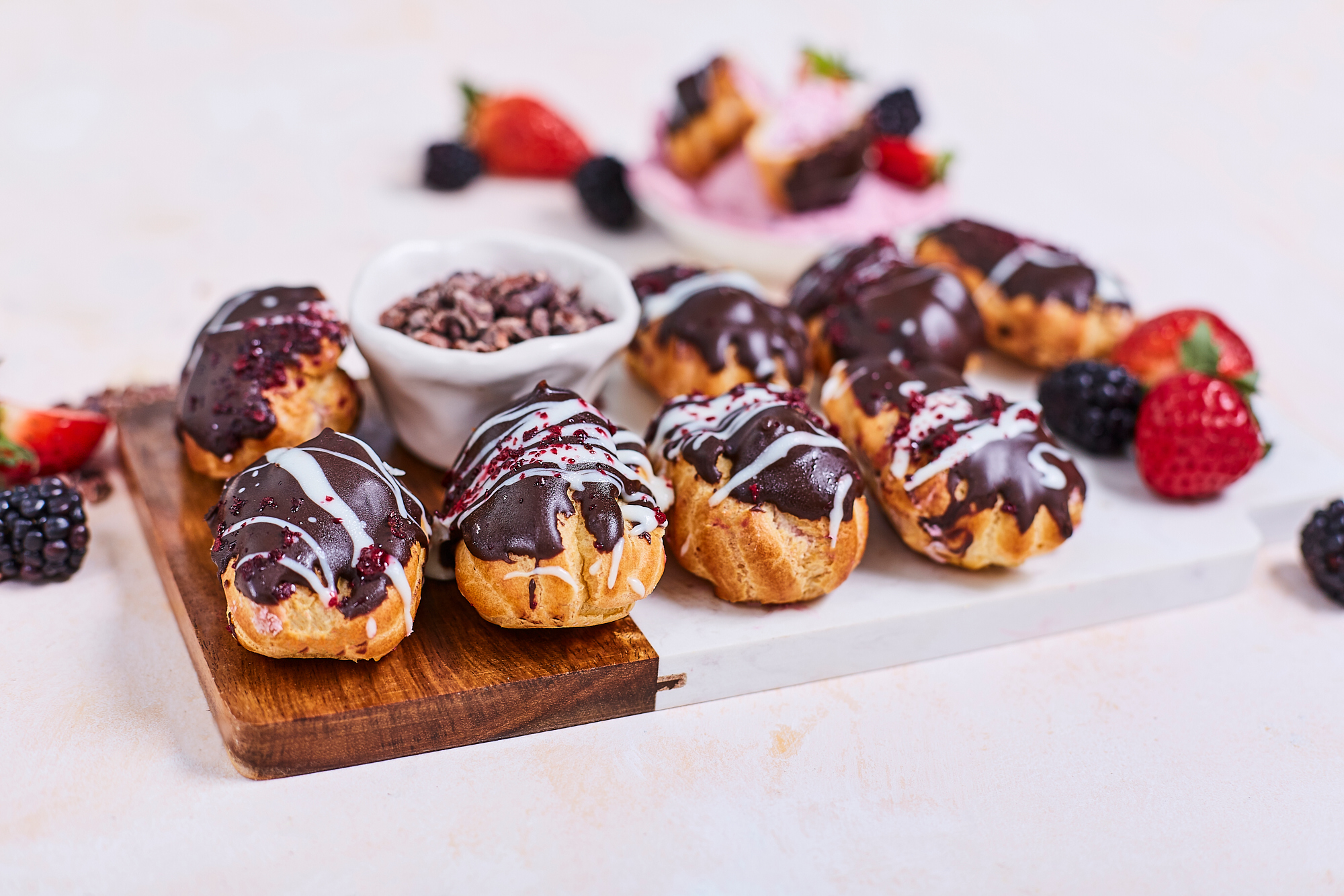 Mini Eclairs with berry filling in dark chocolate